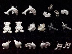 SEVEN PAIRS OF STERLING SILVER STUD EARRINGS. DOLPHINS, CROSS, ELEPHANT, MUSIC NOTE, HEARTS, TEDDY