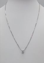 An 18 K white gold chain necklace with a quality diamond solitaire pendant (0.30 carats). Chain