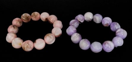 A Purple and a Pink Polished Conch Shell Expandable Bracelet.
