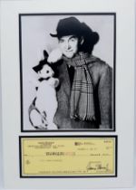 A PHOTO OF JIMMY STEWART AND THE FAMOUS WHITE RABBIT "HARVEY" WITH A SIGNED CHEQUE FROM HIS PERSONAL