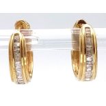 A Pair of 10K Yellow Gold and Diamond Earrings. Small baguette diamond decoration. 3.2g total