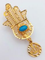 An 18K Yellow Gold 'Hand of God' Brooch. Turquoise cabochon decoration. 4.5cm. 3.5g total weight.