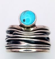A Sterling Silver Mexican Turquoise Set Bark Pattern. Ring size L. The ring measures 1.7cm wide at