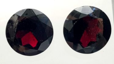 A Pair of 67.32ct Round Brilliant Shaped Dark Red Garnets. 20mm. AIG Milan Certified.