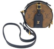 A Cute Louis Vuitton Boite Chapeau Crossbody Bag. Monogram leather exterior with gold-tone hardware.