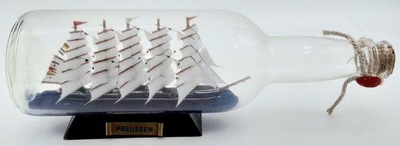 A Ship in a Bottle. Good condition in original packaging. 30cm length.
