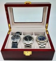 A Parcel of Three Men’s Watches Contained in a Piano Wood Finish Three Watch Travel Display Case.