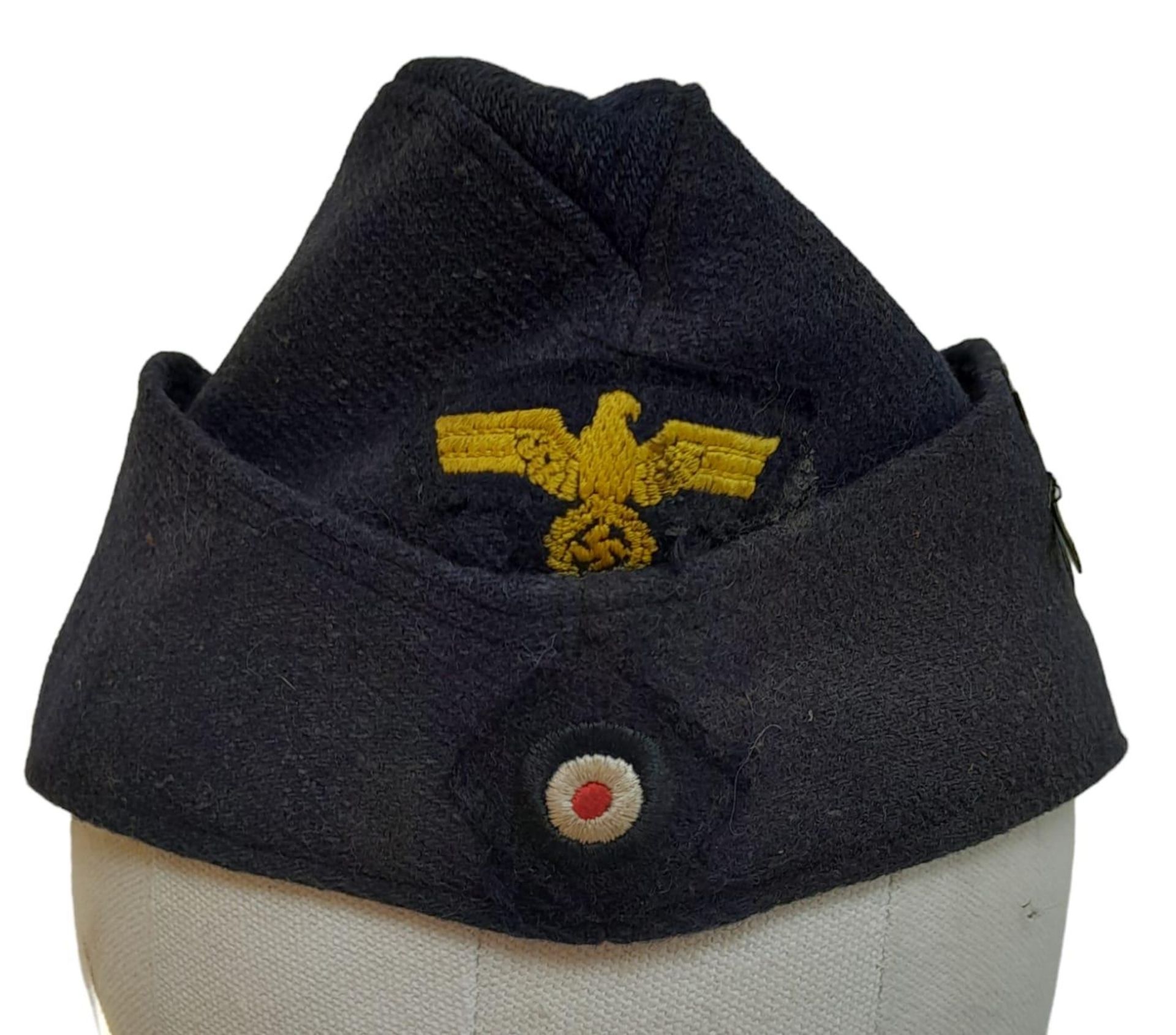 A WW2 German Kriegsmarine Enlisted Man’s Side Cap with U-Boat Flotilla Insignia.