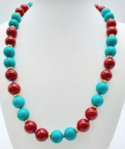 A Vibrant Turquoise and Red Coral Bead Necklace. Gilded and white stone spacers. 12mm beads. 46cm