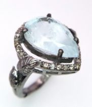 An Aquamarine and Diamond 925 Silver Ring. Central 8ct pear-shaped aquamarine with 0.50ctw of