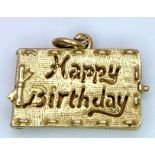 A 9 K yellow gold "Happy Birthday" charm that opens. weight: 2.7 g.