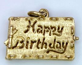 A 9 K yellow gold "Happy Birthday" charm that opens. weight: 2.7 g.