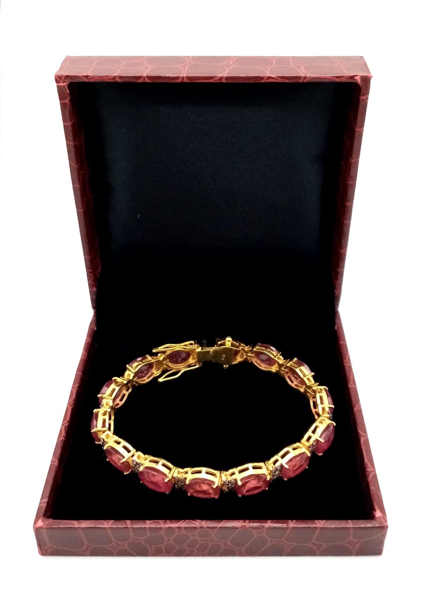 An Oval Cut Ruby and Diamond Gemstone Tennis Bracelet set in Gold Plated 925 Silver. 50ctw Rubies - Image 3 of 4