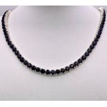 A Blue Sapphire Gemstone Tennis Necklace set in 925 Silver. 45cm length. 40.15g total weight.