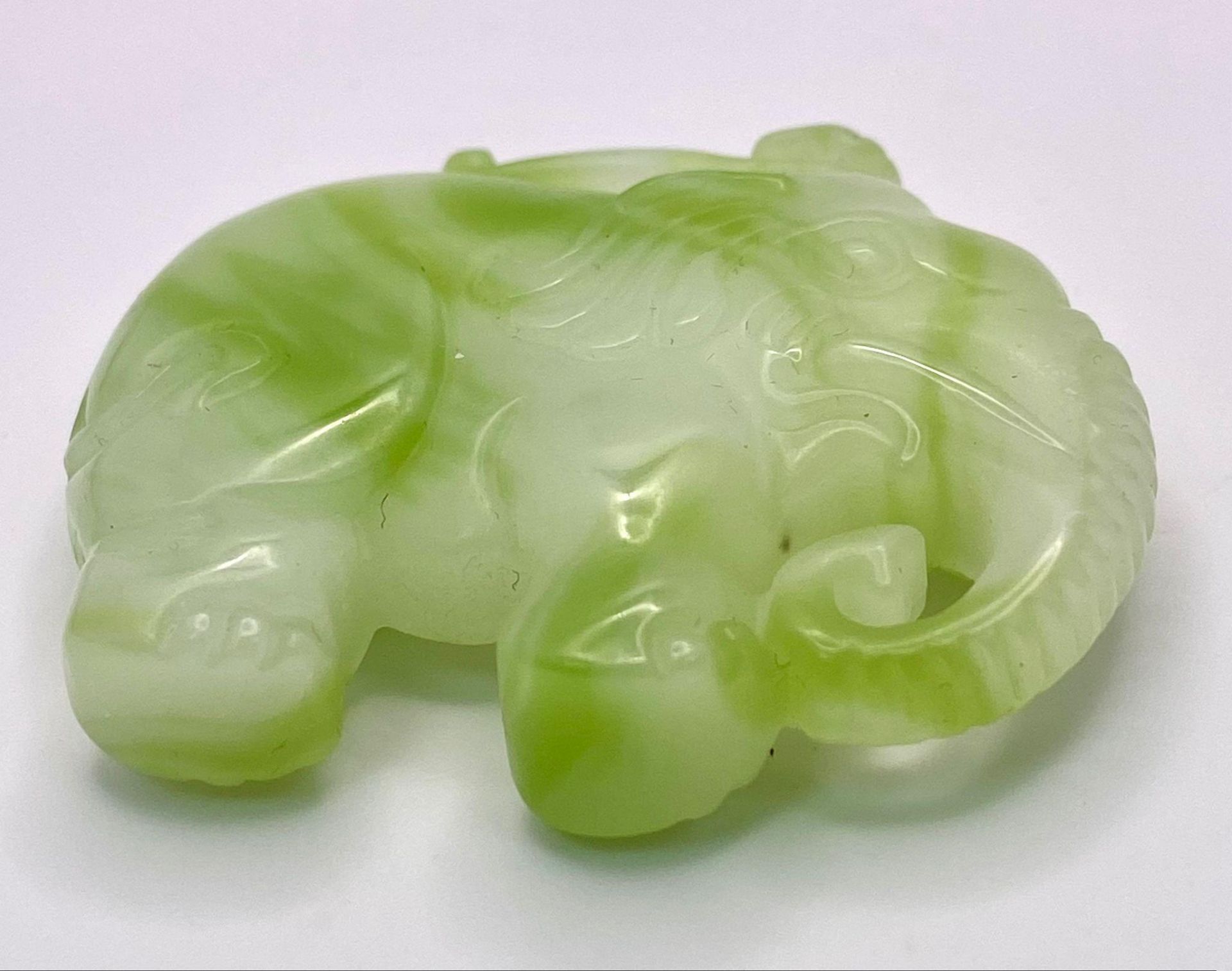 A Chinese Cauliflower Jade Elephant Pendant. 5cm x 4cm - Image 2 of 3