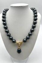A Metallic Grey South Sea Pearl Shell Bead Necklace with Teardrop Pendant. Gilded and white stone