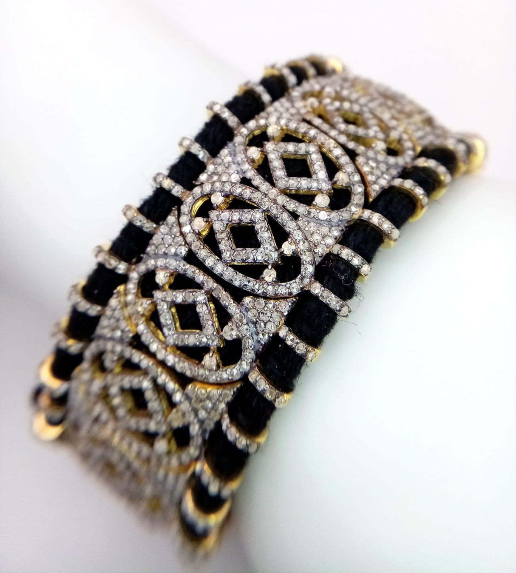 A Diamond Tennis Bracelet with 10ctw (approx) of round cut diamonds set in 925 Silver on a black