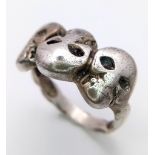 A Sterling Silver Triple Skull Ring. Size W, 7.5g total weight. Ref: SC1124
