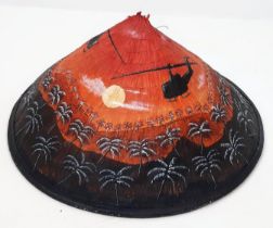 A Vietnamese Bamboo Conical Hat with a post War Hand Painted Helicopter Scene.