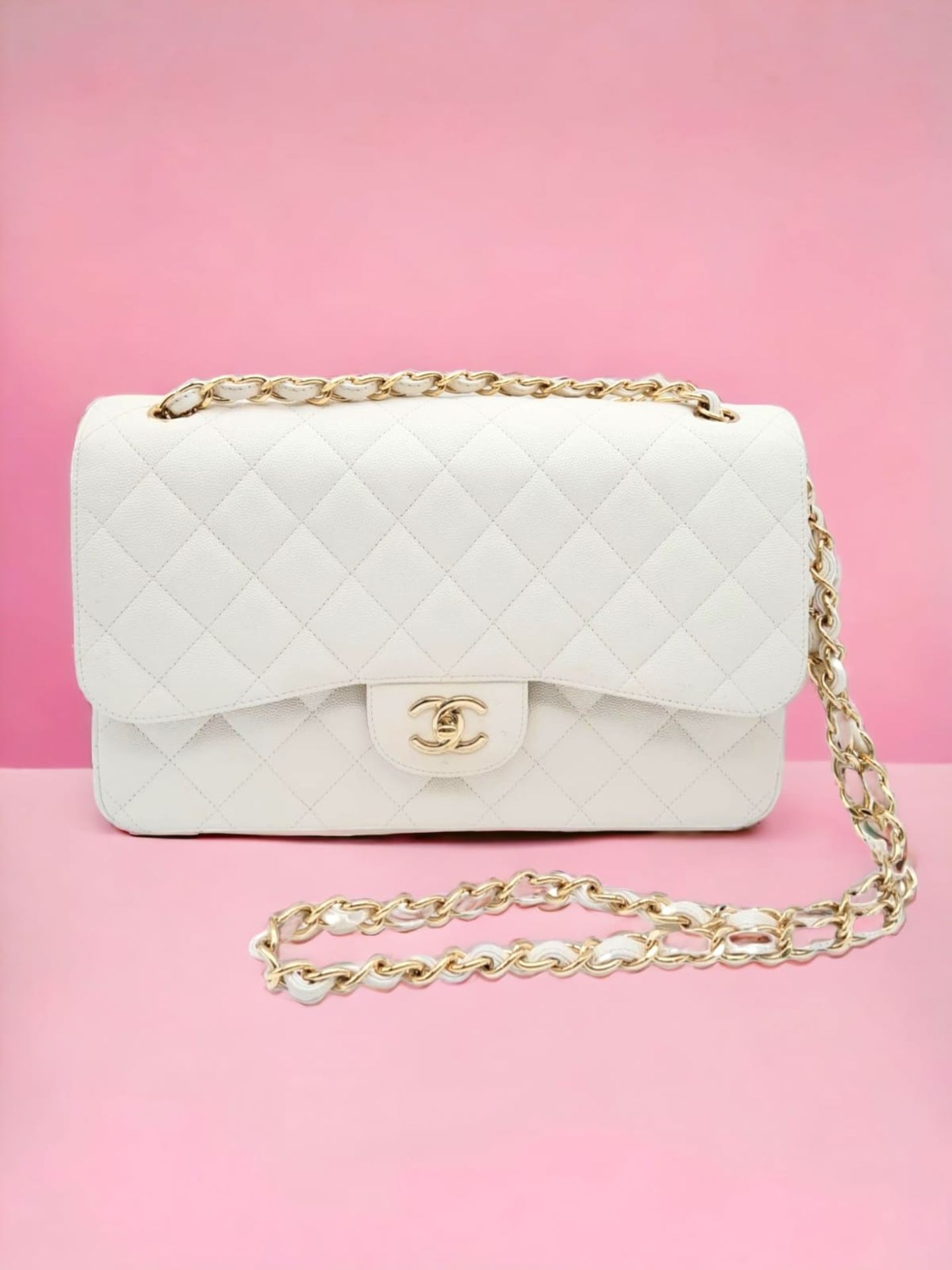 Chanel Caviar Jumbo Single Flap Bag. Quilted white caviar leather stitched in diamond pattern.