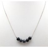 A delicate marblise black Turquoise beaded silver necklace. Total weight 2.85G. Total length 46cm.