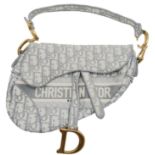 A Christian Dior Grey Saddle Bag, Gold tone hardware and Dior letter charm, comes with the