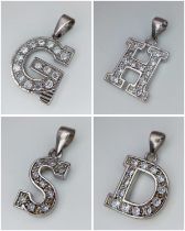 A SELECTION OF 4 STERLING SILVER STONE SET INITIAL PENDANTS H, S, D & G. 8.3G.