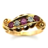 AN ANTIQUE 18K GOLD RING WITH DELICATE SCROLL WORK ENCASING DIAMONDS AND PINK RUBY . 4.4gms size P/Q