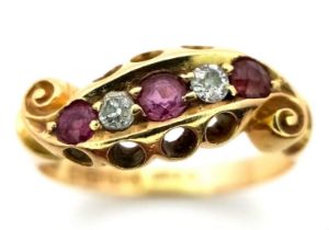 AN ANTIQUE 18K GOLD RING WITH DELICATE SCROLL WORK ENCASING DIAMONDS AND PINK RUBY . 4.4gms size P/Q