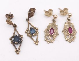 Two antique pairs of 9 K yellow gold earrings, one with oval cut rubies the other one with
