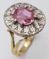 A NATURAL BURMESE RUBY SURROUNDED BY DIAMONDS AND SET IN 18K GOLD . 6.8gms size Q