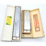 A Vintage German Koch Harmonica and a Chinese Hero Harmonica. Both in original boxes.