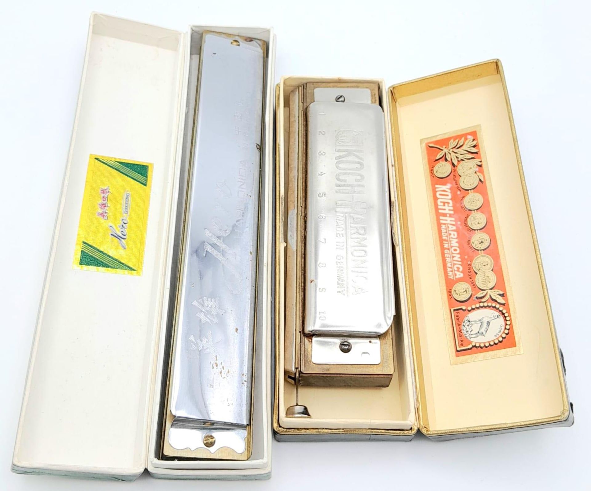 A Vintage German Koch Harmonica and a Chinese Hero Harmonica. Both in original boxes.