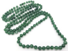 A superb, long beaded Jade necklace. Measuring 124 cm in length, with rich, deep, mesmerising