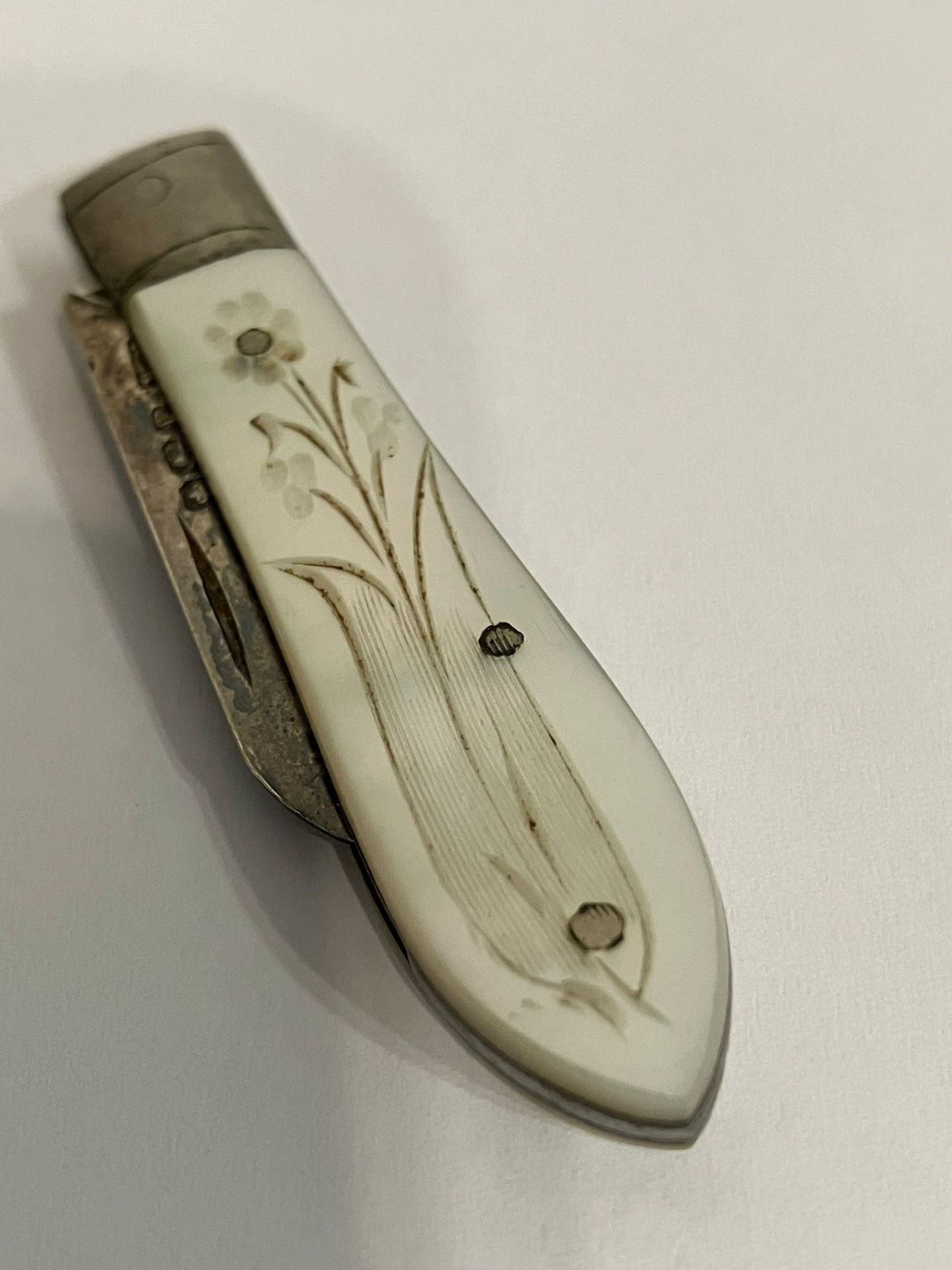 Antique SILVER BLADED FRUIT KNIFE . Having mother of pearl handle with floral engraving. Purse size.