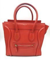 A Celine Coral Luggage Bag. Leather exterior with two rolled leather handles, a zipped pocket to the