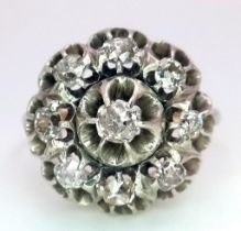 An 18K Yellow and White Gold Diamond Ring. Central brilliant round cut diamond with an eight