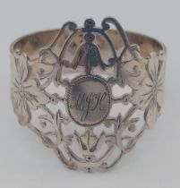 An antique sterling silver filigree napkin ring with full Birmingham hallmarks, 1903. Total weight