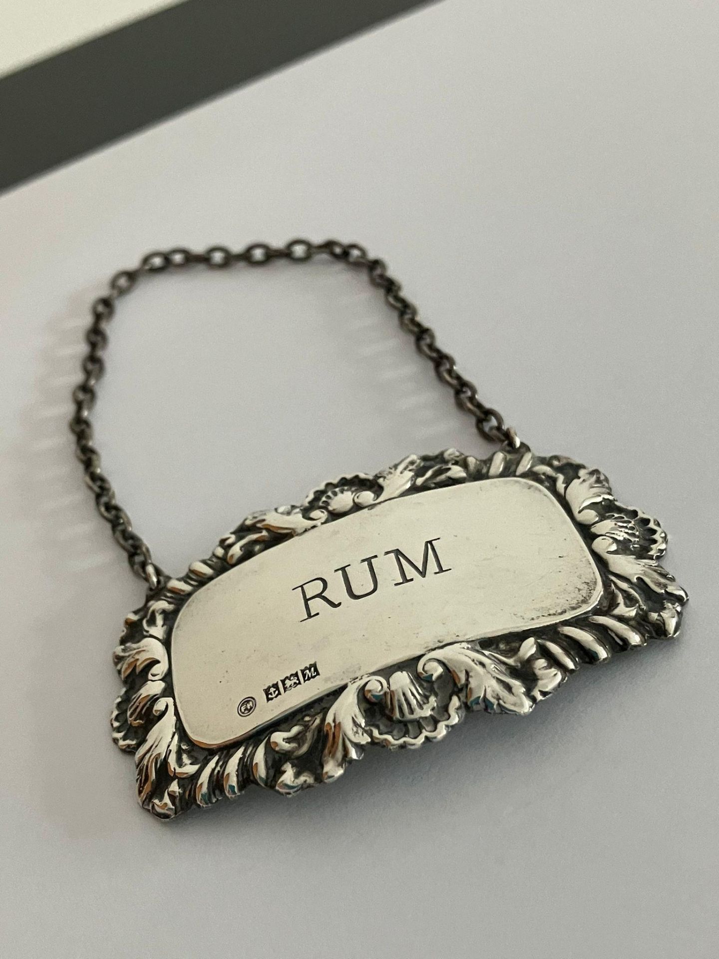 Vintage SILVER DECANTER LABEL for RUM. Attractive Silver work surround having shell and leaf detail.