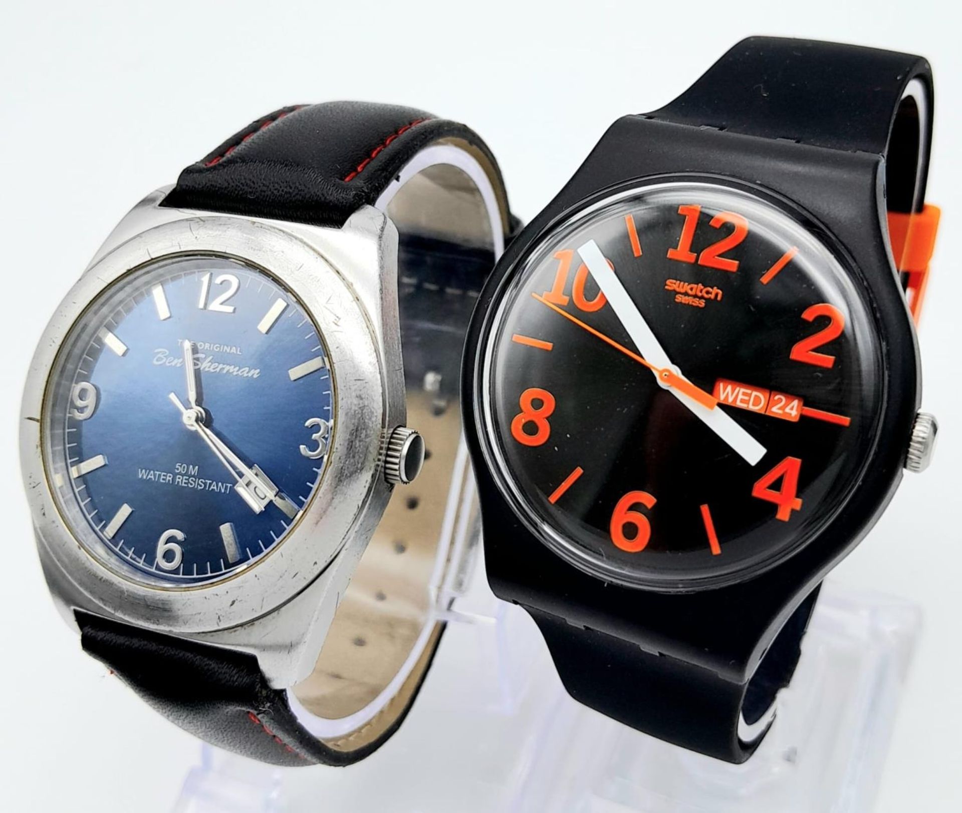 A Parcel of Two Men’s Watches. Comprising: 1) An unused Swatch Day/Date Watch (42mm Including