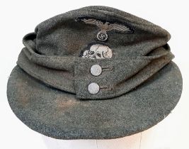 3rd Reich Waffen SS M43 Cap. very small cut on the top. A real “Been There” item.