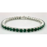 An Emerald Tennis Bracelet set in 925 Silver. 18cm length. 16.5g total weight. Ref: Cd-1032