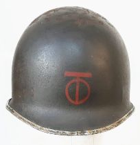 WW2 US Fixed Bale M1 Helmet, with insignia of the 90th Infantry Division.
