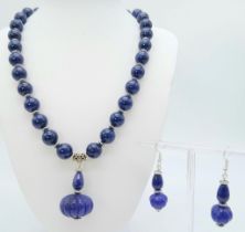 A vintage, Tibetan lapis lazuli necklace with a gourd shaped lavaliere and accompanied by matching