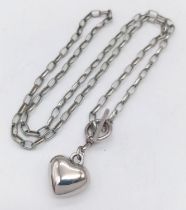 A vintage 925 silver heart pendant on silver T-bar chain. Total weight 11.6G. Total length 48cm.
