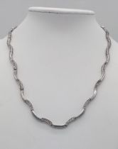 A vintage 925 silver Zirconia link wave necklace with London hallmark. Total weight 15.7G. Total