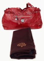 A Mulberry Patent Red Leather Handbag. Textured exterior with a central zipped pocket. Silver-tone