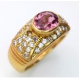 An 18K YELLOW GOLD DIAMOND & PINK GEMSTONE (BELIEVED TO BE SAPPHIRE) RING. 0.50CT. 6.6G. SIZE K