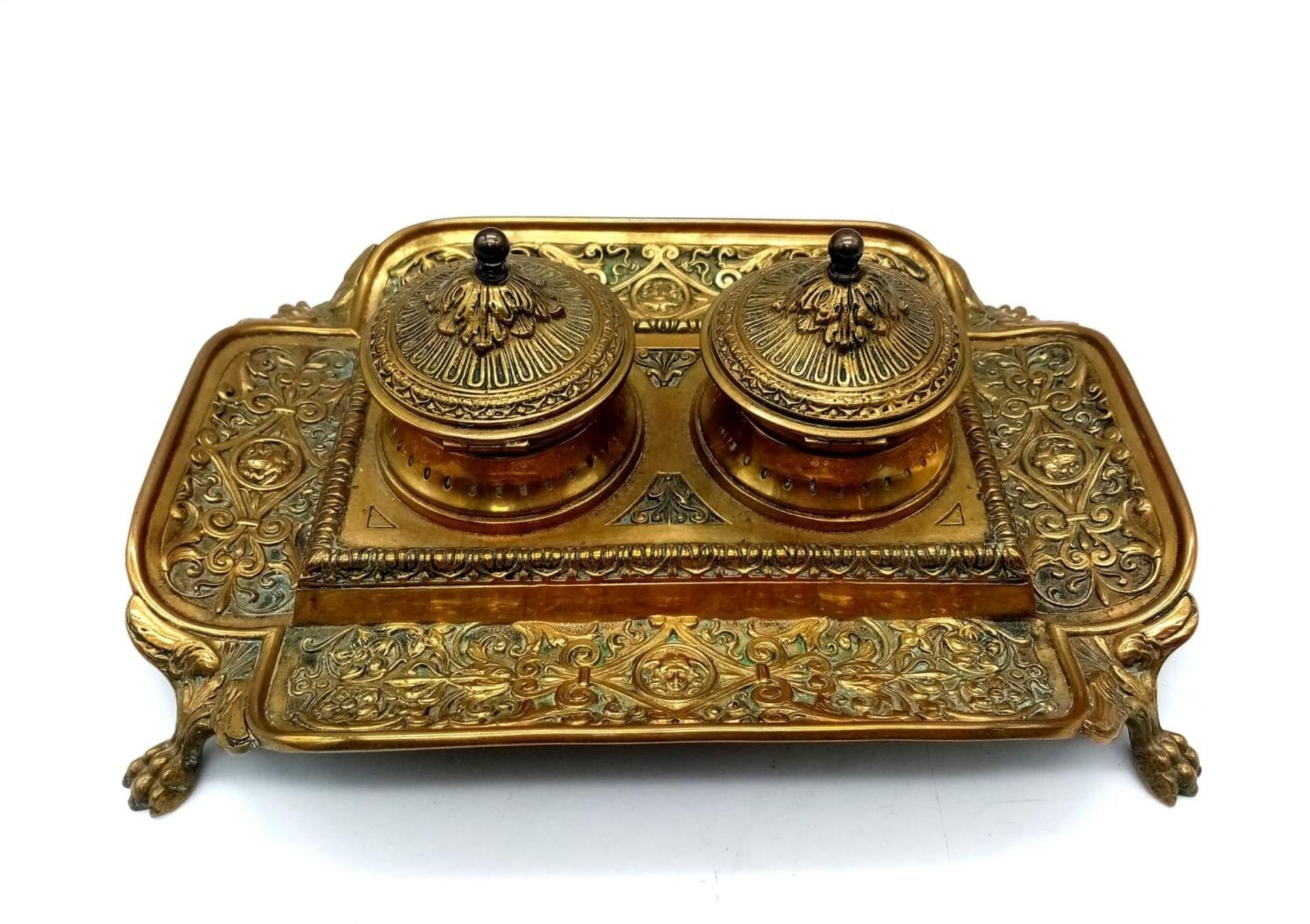 An Antique Brass (Possibly French) Double Inkwell. Ornate regal scroll decoration throughout with