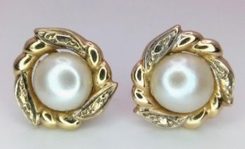 A fancy pair of 9CT gold pearl flower earrings. Total weight 2.12G.